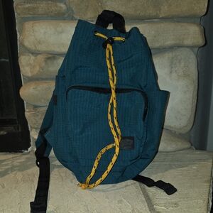 Vans Going Places Drawstring Bucket Backpack features a Contrasting Yellow Cord